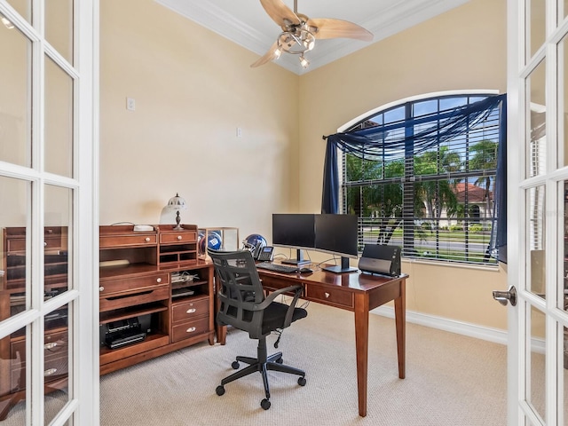 carpeted office space featuring ceiling fan, ornamental molding, and french doors