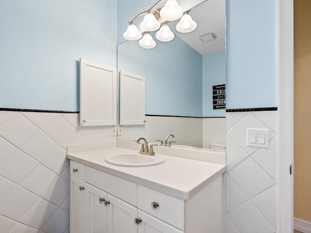 bathroom featuring vanity and tile walls