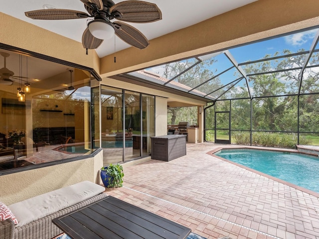 view of swimming pool featuring ceiling fan, a patio area, and exterior kitchen