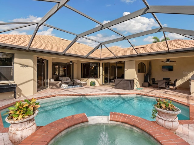 view of swimming pool featuring a lanai, ceiling fan, a patio, and an in ground hot tub