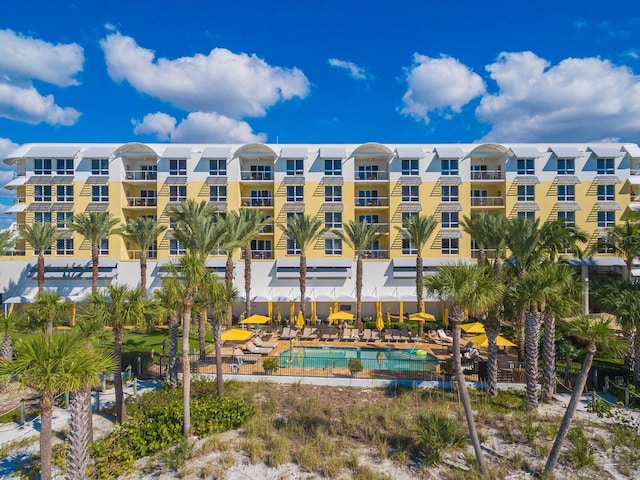 view of building exterior featuring a community pool