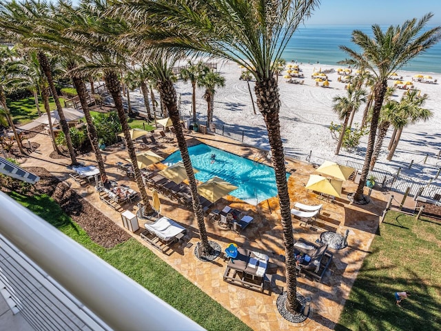 view of pool featuring a patio and a water view