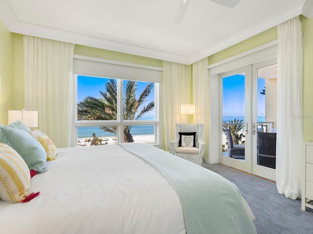 carpeted bedroom with a water view, access to outside, ceiling fan, and french doors