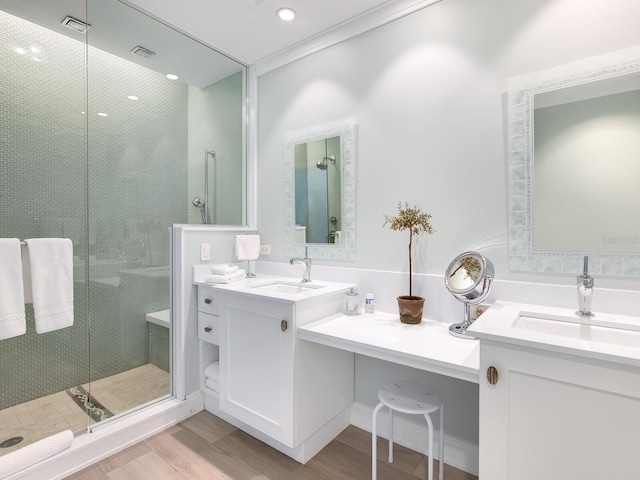 bathroom featuring vanity, wood-type flooring, walk in shower, and ornamental molding