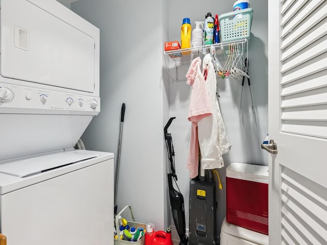 washroom featuring stacked washing maching and dryer