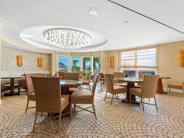 dining space featuring a tray ceiling