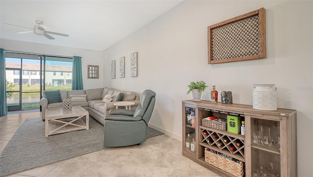 living room featuring ceiling fan and light tile patterned floors