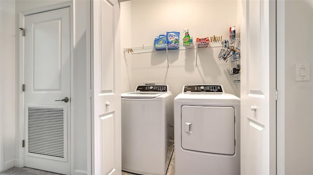 clothes washing area with independent washer and dryer