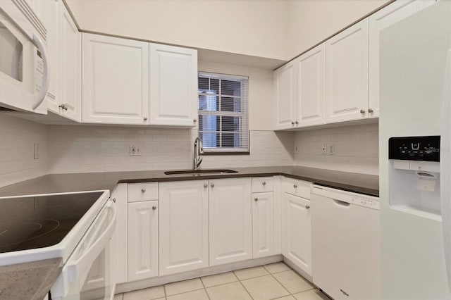 kitchen featuring white cabinetry, sink, backsplash, white appliances, and light tile patterned floors