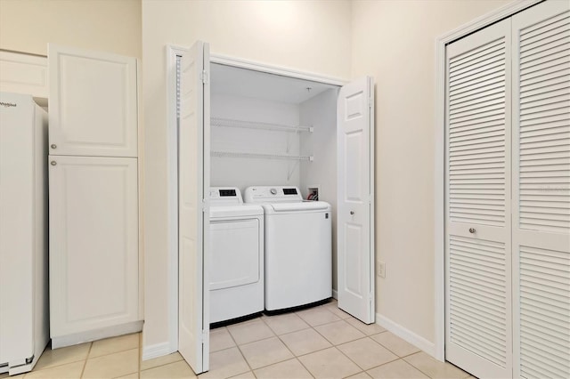 washroom featuring independent washer and dryer and light tile patterned floors