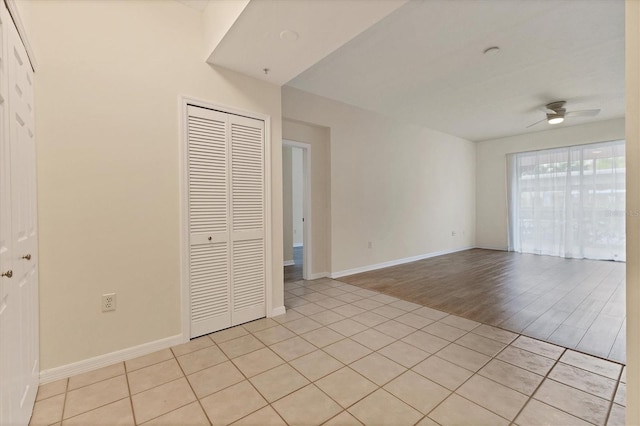 empty room featuring light wood-type flooring and ceiling fan