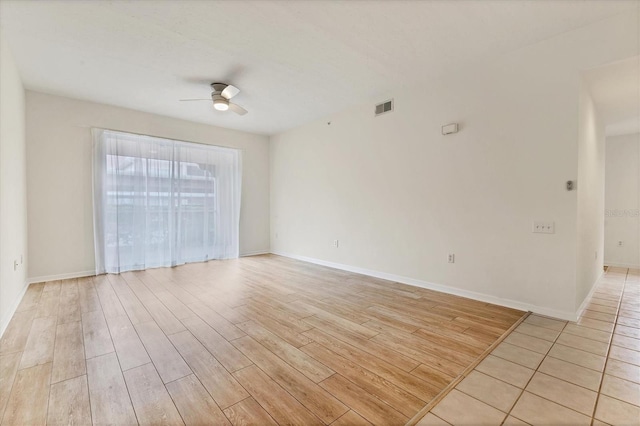 empty room with ceiling fan and light wood-type flooring