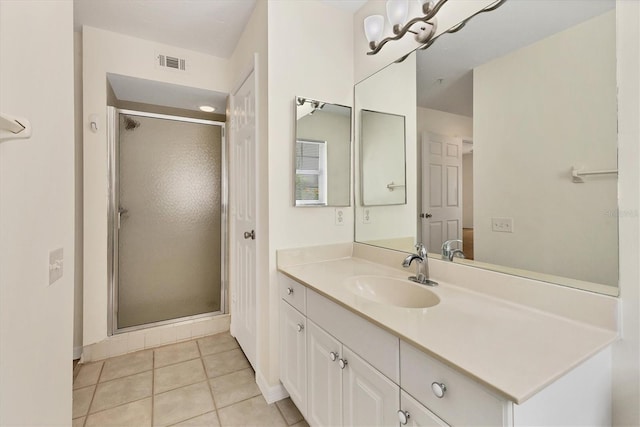 bathroom with tile patterned floors, vanity, and a shower with shower door