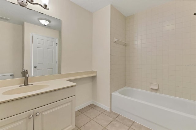 bathroom with vanity, tile patterned floors, and tiled shower / bath