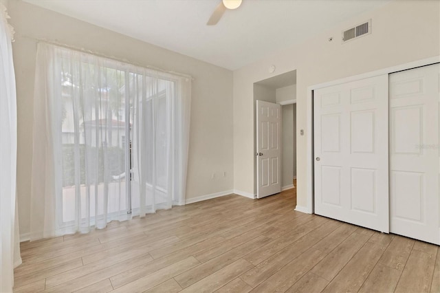 unfurnished bedroom featuring ceiling fan, light hardwood / wood-style floors, and a closet