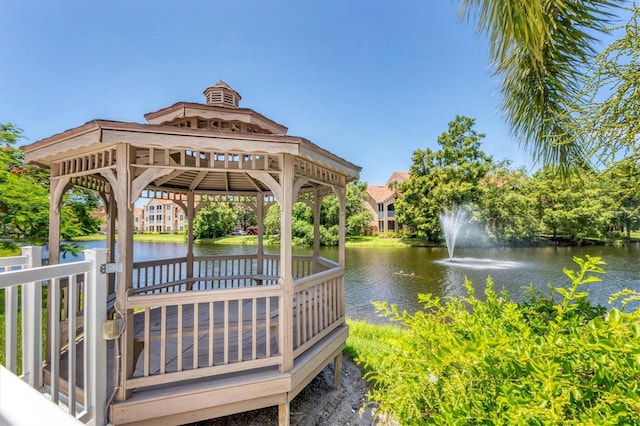 view of dock featuring a gazebo and a water view