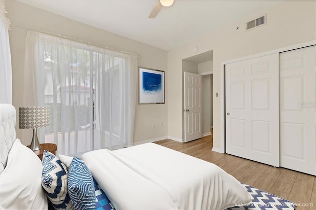 bedroom featuring light wood-type flooring, a closet, and ceiling fan