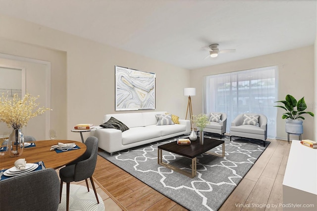 living room featuring ceiling fan and hardwood / wood-style flooring