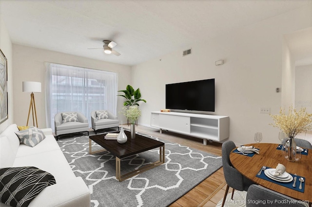 living room featuring ceiling fan and hardwood / wood-style floors