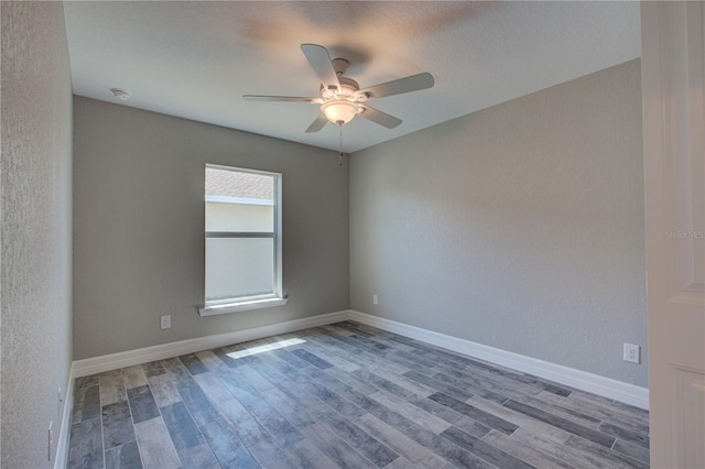 spare room featuring ceiling fan and wood-type flooring