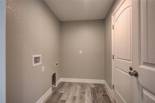 washroom featuring hardwood / wood-style flooring, washer hookup, and hookup for an electric dryer