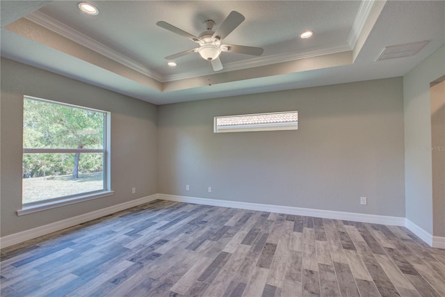 empty room with light hardwood / wood-style floors, plenty of natural light, and ornamental molding