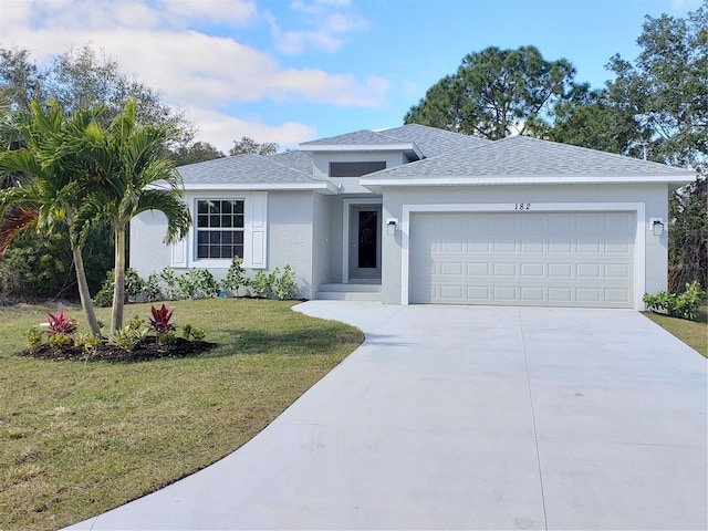 view of front of home featuring a front yard and a garage