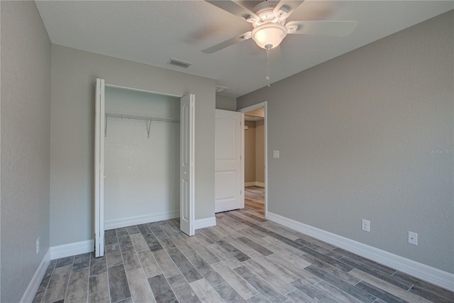 unfurnished bedroom with ceiling fan, a closet, and light hardwood / wood-style floors