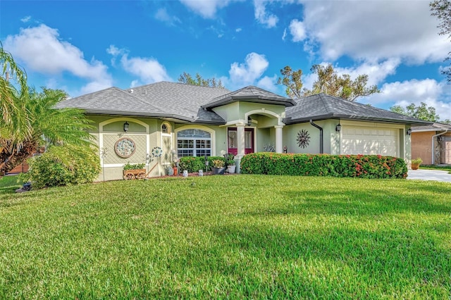 view of front of house featuring a front lawn and a garage