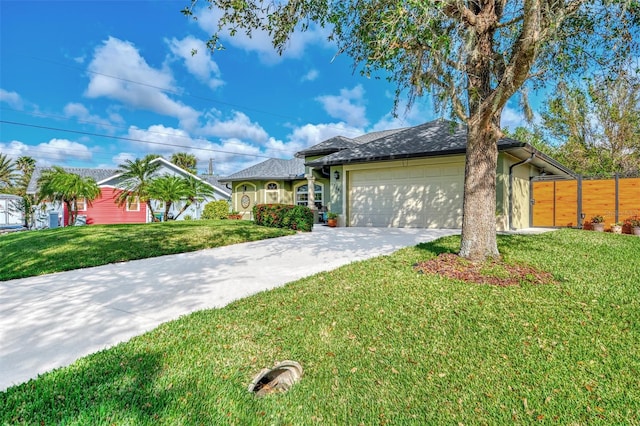 view of front of property featuring a front yard and a garage