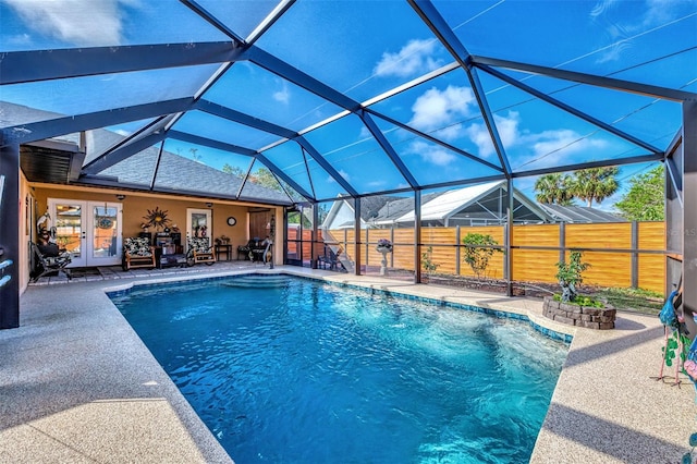 view of pool with french doors, a patio area, and a lanai