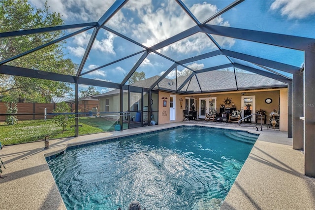 view of swimming pool with a lanai, a patio area, and ceiling fan