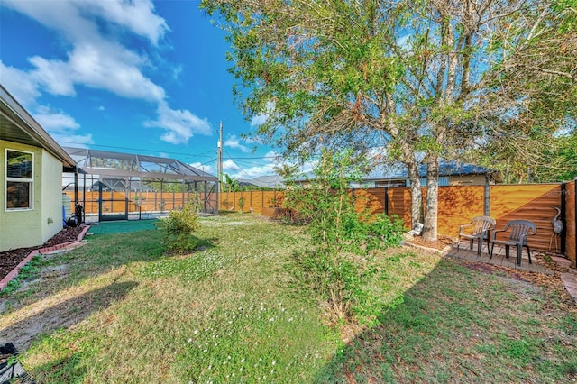 view of yard featuring a lanai and a patio