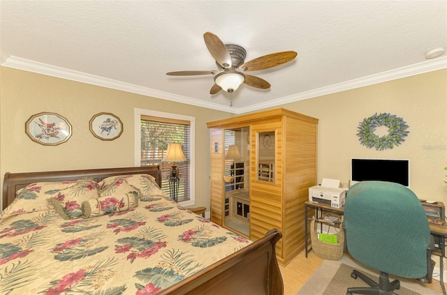 bedroom featuring ceiling fan, crown molding, and a textured ceiling