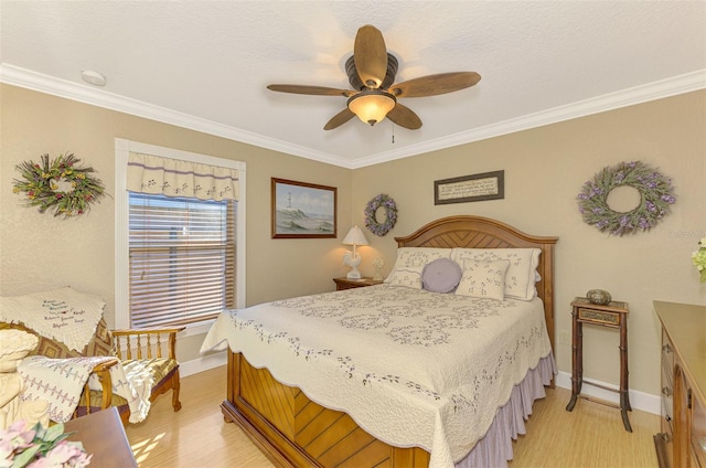 bedroom with light hardwood / wood-style flooring, ceiling fan, and crown molding