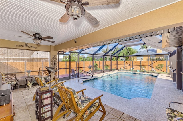 view of swimming pool featuring glass enclosure and a patio area