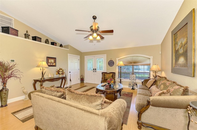 living room featuring ceiling fan, french doors, vaulted ceiling, and light wood-type flooring