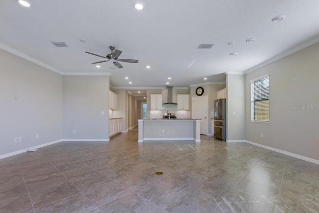 unfurnished living room featuring ceiling fan and ornamental molding