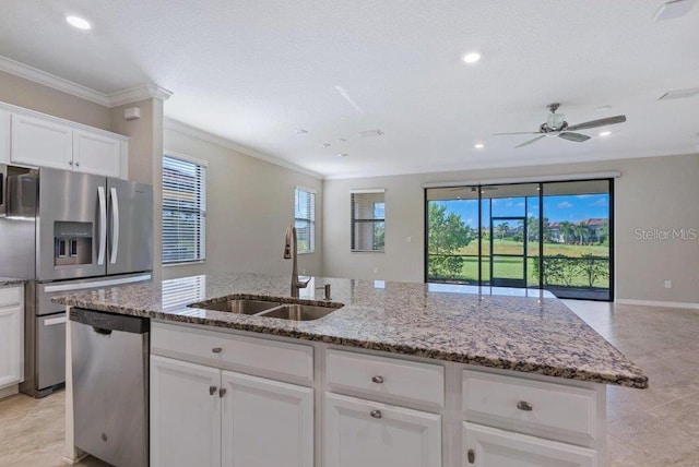 kitchen featuring stainless steel appliances, white cabinetry, crown molding, and sink