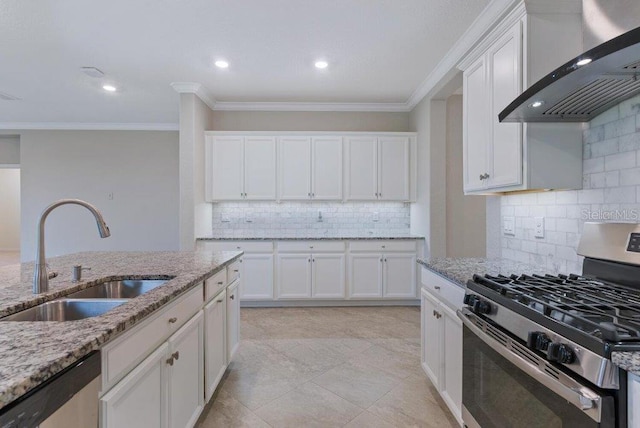 kitchen with white cabinets, wall chimney range hood, sink, and appliances with stainless steel finishes