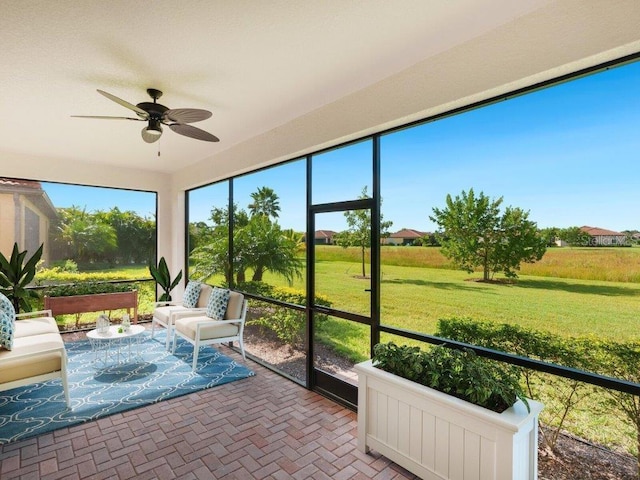 sunroom / solarium featuring ceiling fan