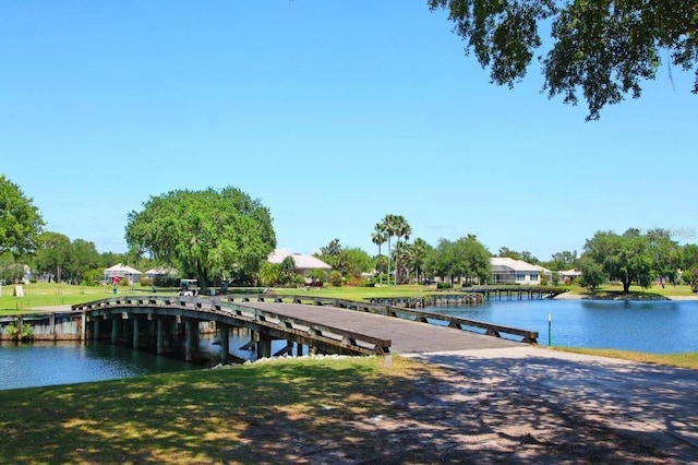 dock area featuring a lawn and a water view