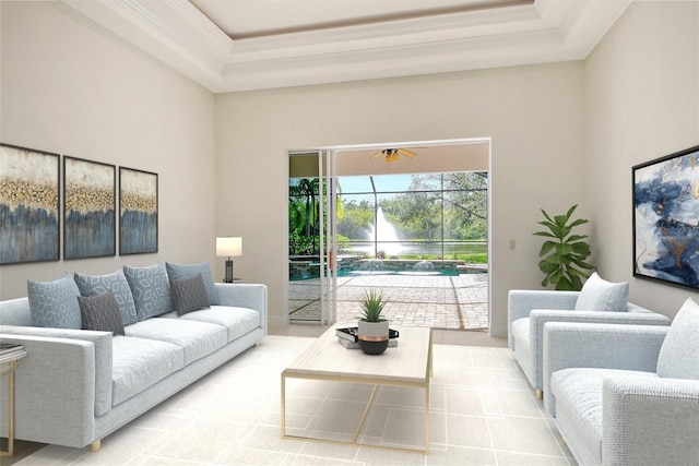 living room with ceiling fan, a towering ceiling, and a raised ceiling