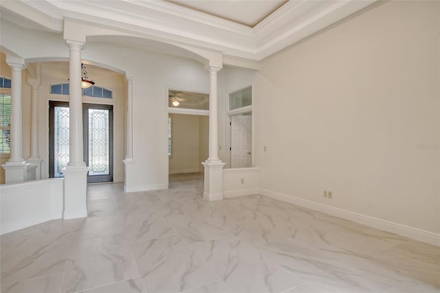 entryway with a raised ceiling and ornamental molding