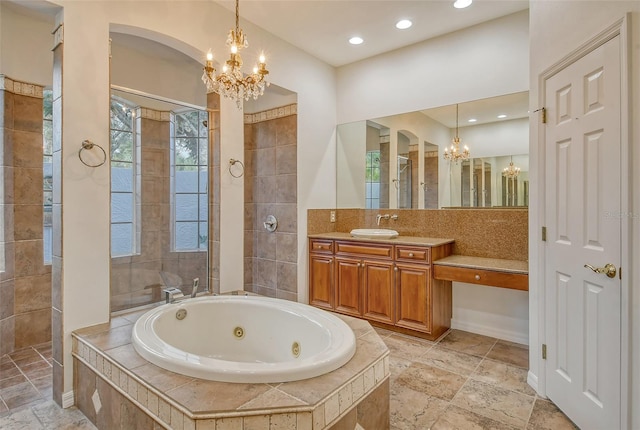 bathroom featuring independent shower and bath, vanity, and a chandelier