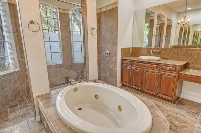 bathroom featuring shower with separate bathtub, vanity, and an inviting chandelier