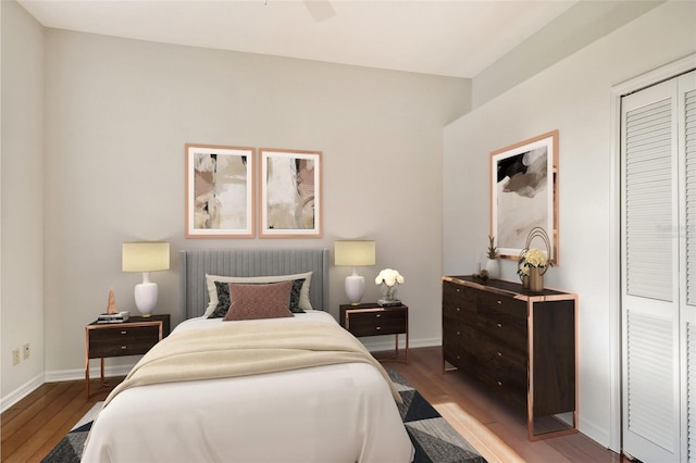 bedroom featuring ceiling fan, a closet, and light hardwood / wood-style flooring