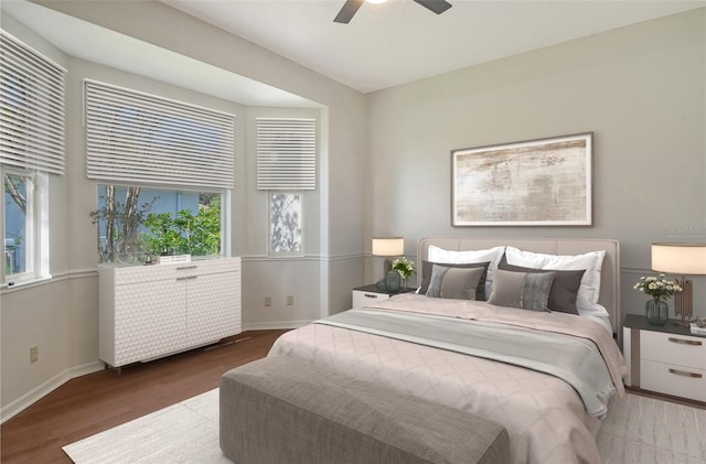 bedroom with ceiling fan and hardwood / wood-style flooring