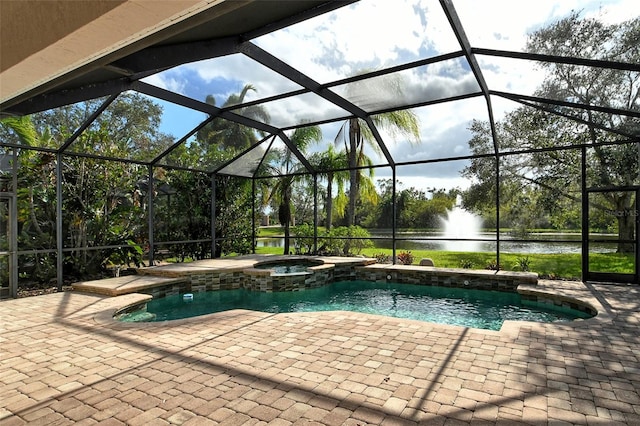 view of pool with an in ground hot tub, a lanai, a water view, and a patio