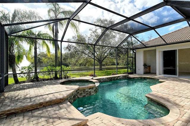 view of pool with a patio area, glass enclosure, and an in ground hot tub